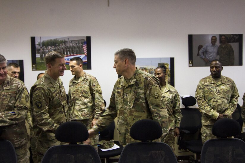 Two Army leaders shake hands.