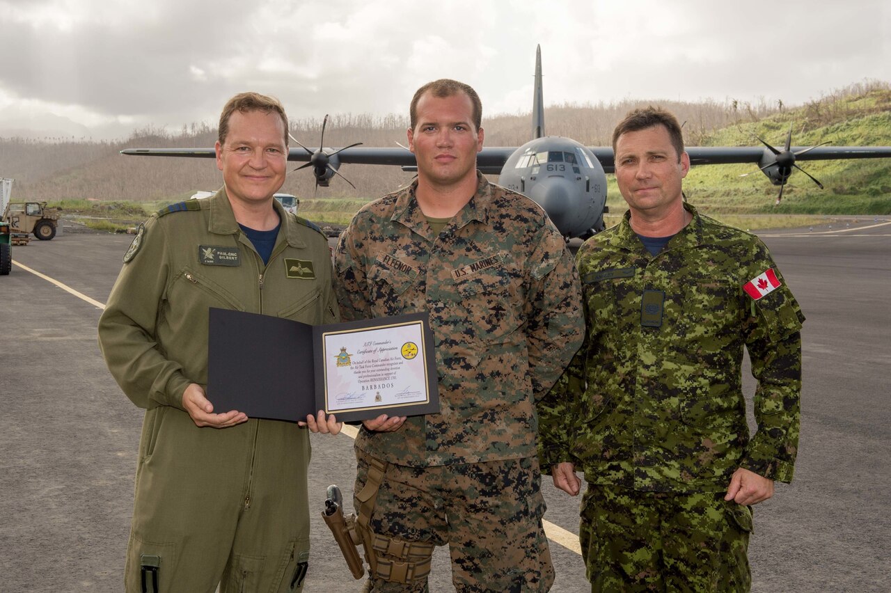 Marine receives award from Royal Canadian Air Force officials.