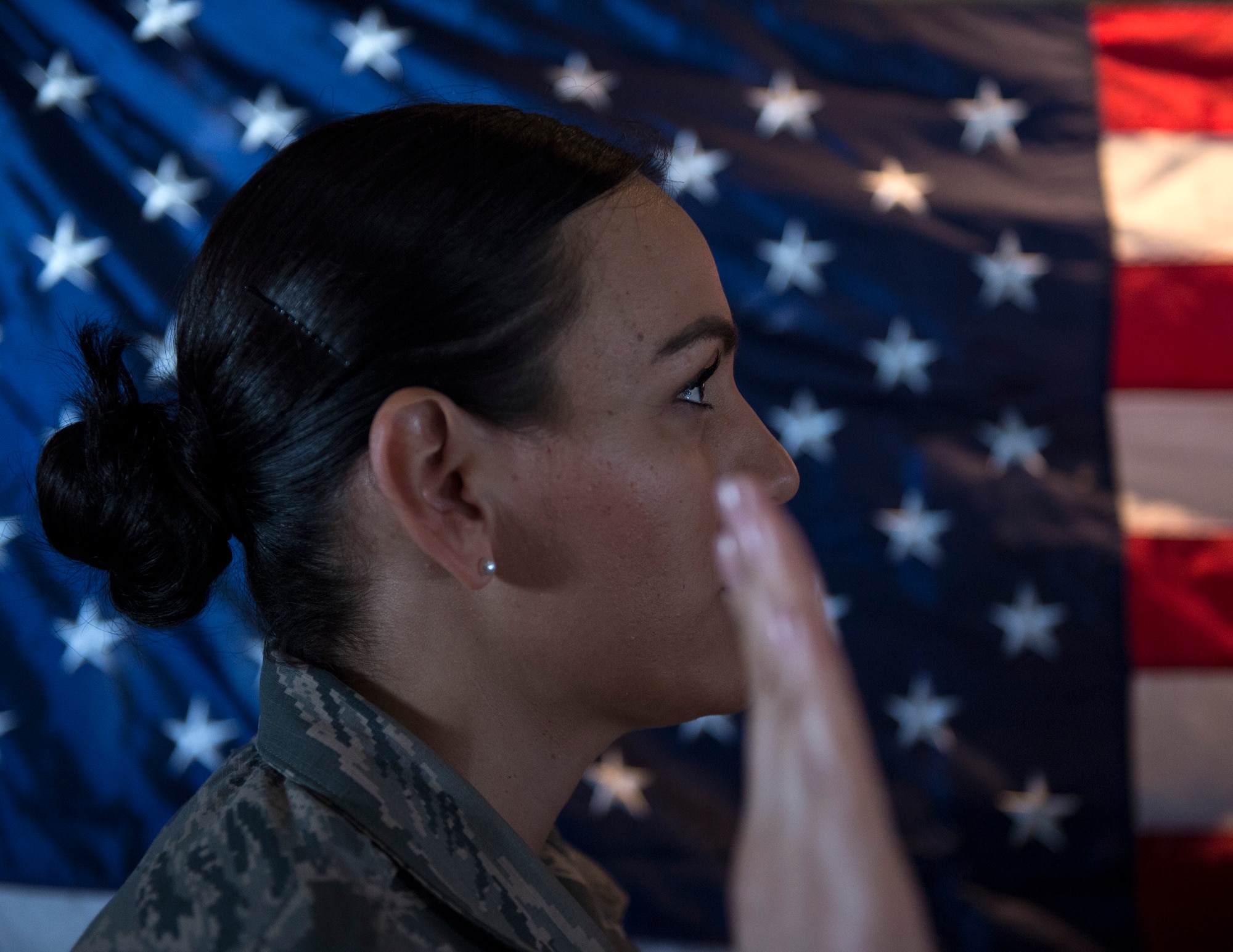 U.S. Air Force Staff Sgt. Isela Gonzalez, chaplain assistant with the 379th Air Expeditionary Wing Chapel, takes the oath of enlistment on board a C-130 Hercules from the 746th Expeditionary Airlift Squadron at an undisclosed location in Southwest Asia, Oct. 3, 2017.