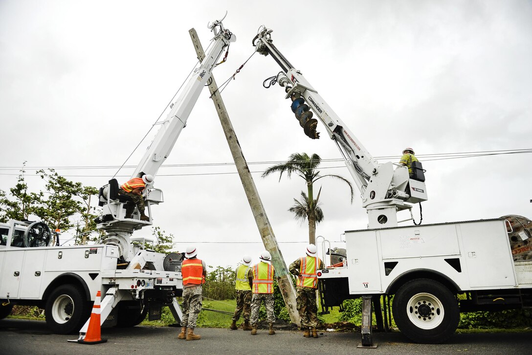 Army Reservists prepare to fix power lines in Puerto Rico.