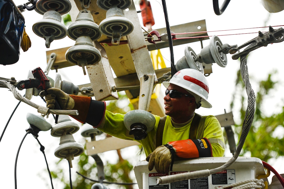 An Army Reservist repairs power lines in Puerto Rico.