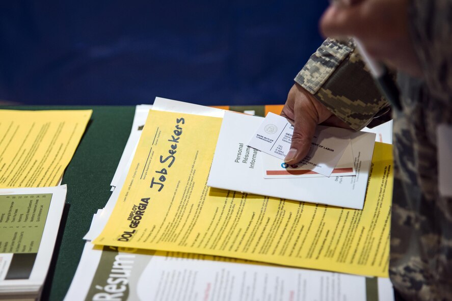 An Airman, grabs pamphlets during the veterans career fair, Oct. 19, 2017, at Moody Air Force Base, Ga. Over 55 potential employers were present to network with attendees, compete for hiring opportunities and schedule interviews. (U.S. Air Force photo by Airman Eugene Oliver)