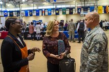 Brittany Moore, left, senior recruiter for a local hardware company, speaks to Senior Master Sgt. Jeremy Carlock, 23d Maintenance Group self-assessment program superintendent, right, and his wife, Shana, during the veteran’s career fair Oct. 19, 2017, at Moody Air Force Base, Ga. Over 55 potential employers were present to network with attendees, compete for hiring opportunities and schedule interviews. (U.S. Air Force photo by Airman Eugene Oliver)