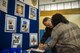 Lashawnya Harris, local community member, signs a contact sheet with Larry Myers, Albany County policeman during the veteran’s career field Oct. 20, 2017, at Moody Air Force Base, Ga. Over 55 potential employers were present to network with attendees, compete for hiring opportunities and schedule interviews. (U.S. Air Force photo by Airman Eugene Oliver)
