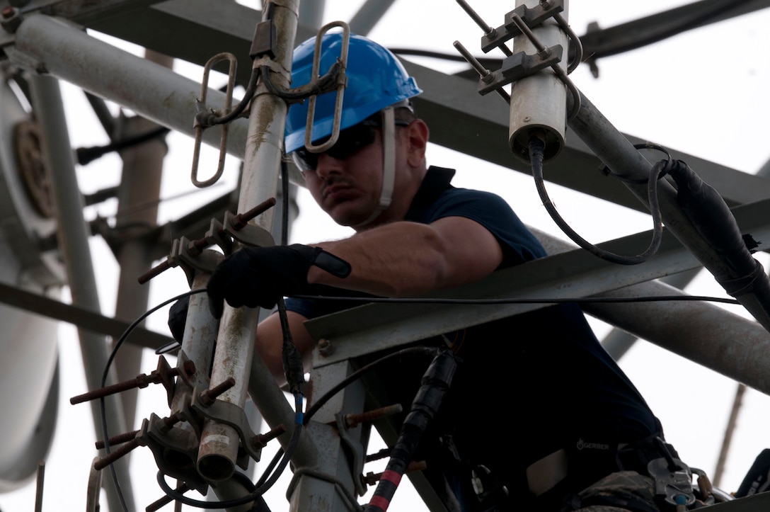 Air Force Capt. Jose Gutierrez del Arroyo, the deputy flight commander and a specialized engineer with the 85th Engineering and Installation Squadron, works on a damaged antenna at Cerra de Punta Mountain near Ponce, Puerto Rico, Oct. 20, 2017. The 85th EIS are working to reestablish and improve radio communications for local emergency personnel and first responders across the island. Army photo by Sgt. Thomas Calvert