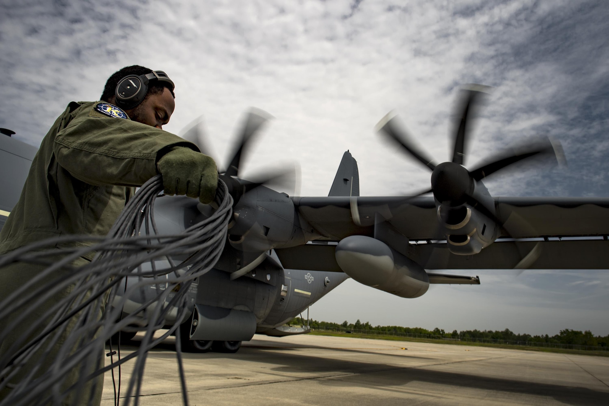 Staff Sgt. Jaime Richardson-Granger, 71st Rescue Squadron loadmaster, bundles a communications cord during engine start-up, May 31, 2017, at Moody Air Force Base, Ga. Responsibilities will vary depending on the aircraft, but generally, loadmasters are responsible for pre-flight inspections of aircraft, loading and unloading of cargo and conducting in-flight checklists. (U.S. Air Force photo by Staff Sgt. Ryan Callaghan)