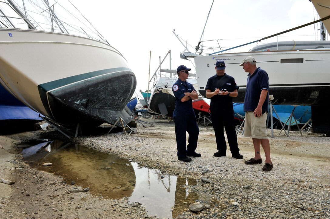 Coast Guardsmen assess the damage of Hurricane Maria.