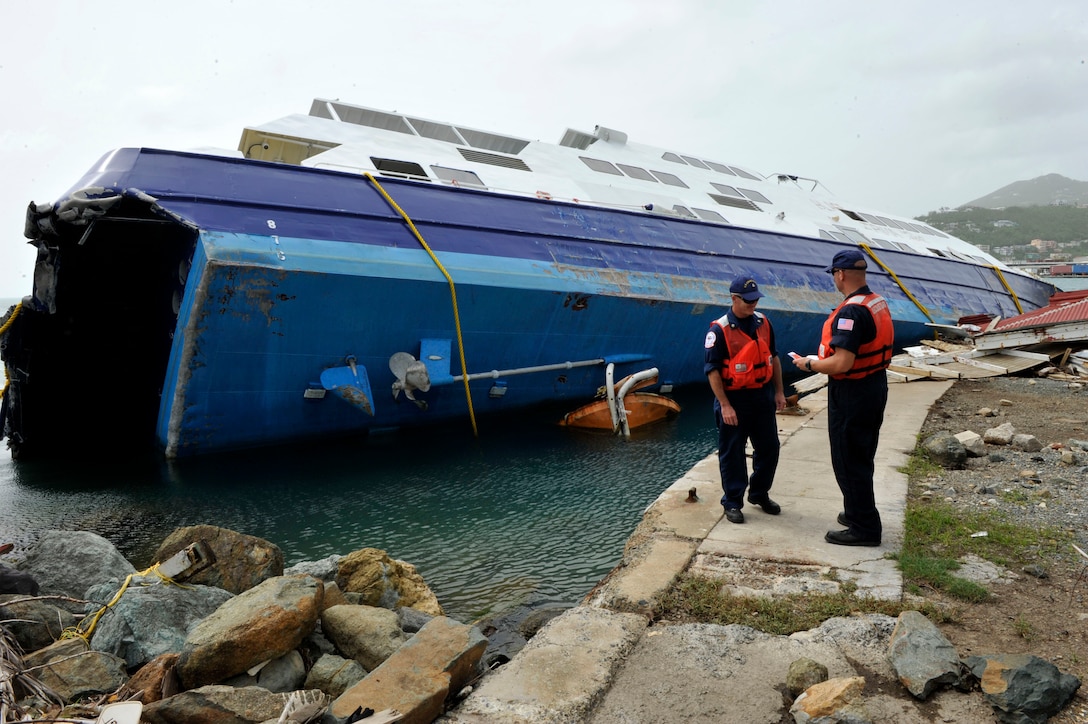 A sunken vessel is assessed for damage.