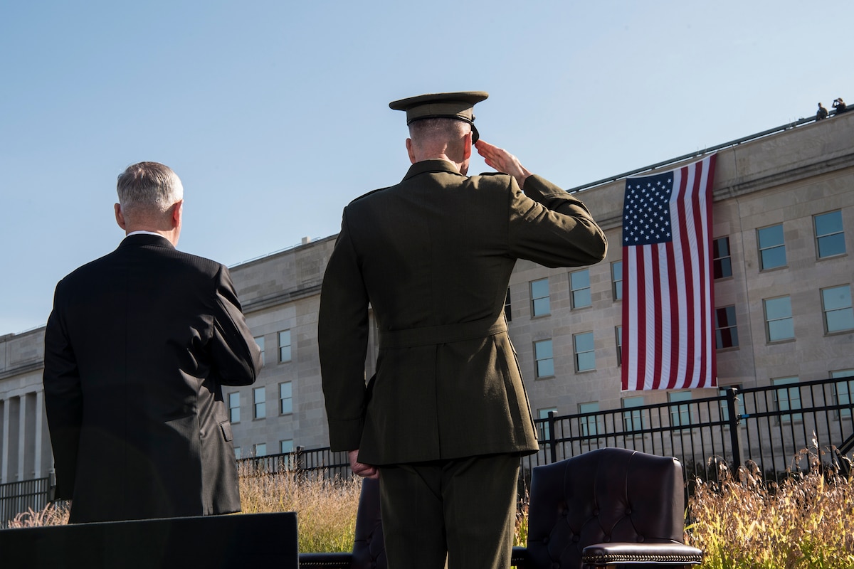 Defense Secretary James N. Mattis and Marine Corps Gen. Joe Dunford salute the flag.