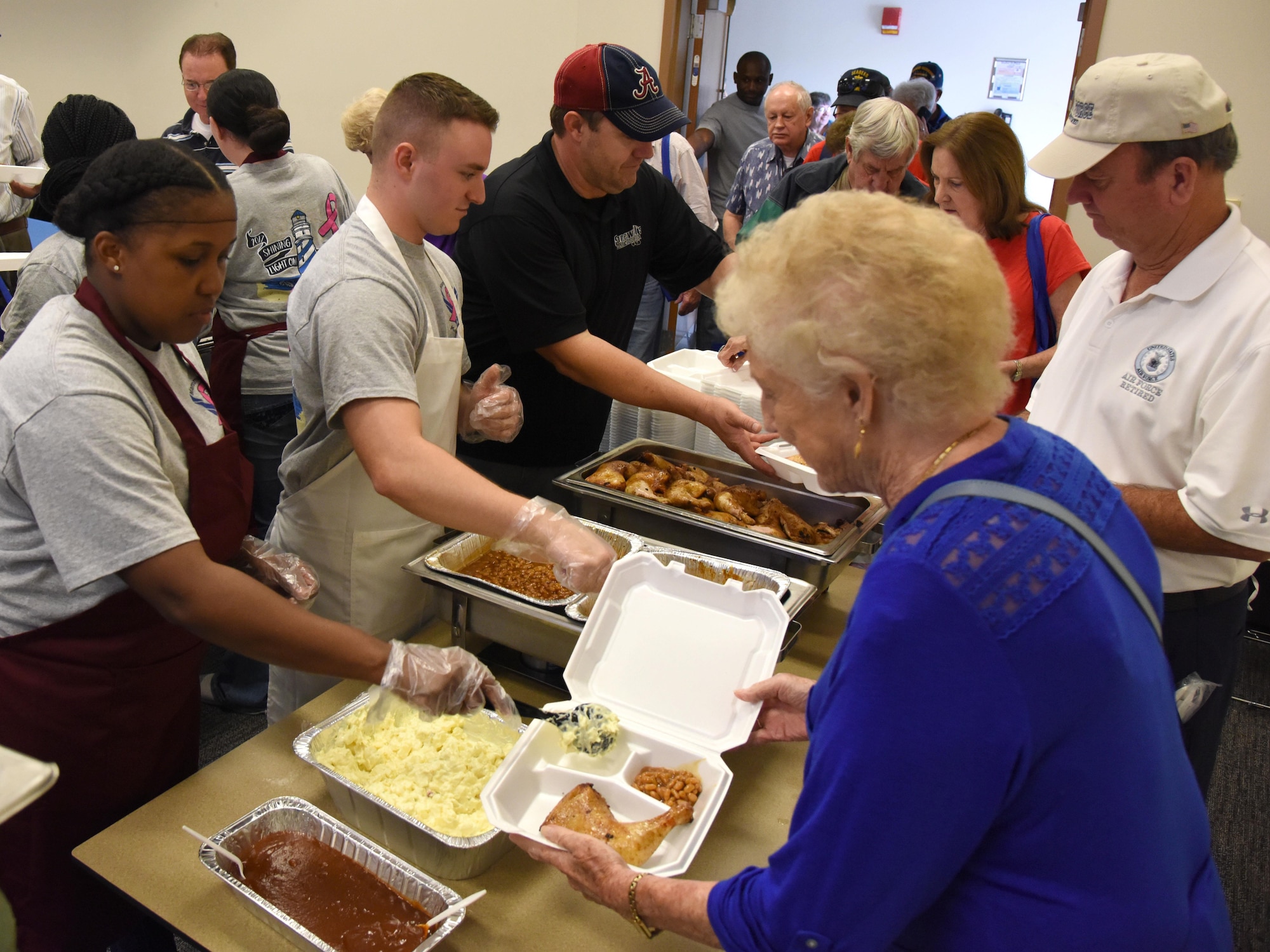 Keesler personnel serve lunch to military retirees during Retiree Appreciation Day at the Roberts Consolidated Aircraft Maintenance Facility Oct. 20, 2017, on Keesler Air Force Base, Mississippi. The annual event, sponsored by the Keesler Retiree Activities Office, included more than 20 displays with information pertinent to retirees and a free lunch. (U.S. Air Force photo by Kemberly Groue)