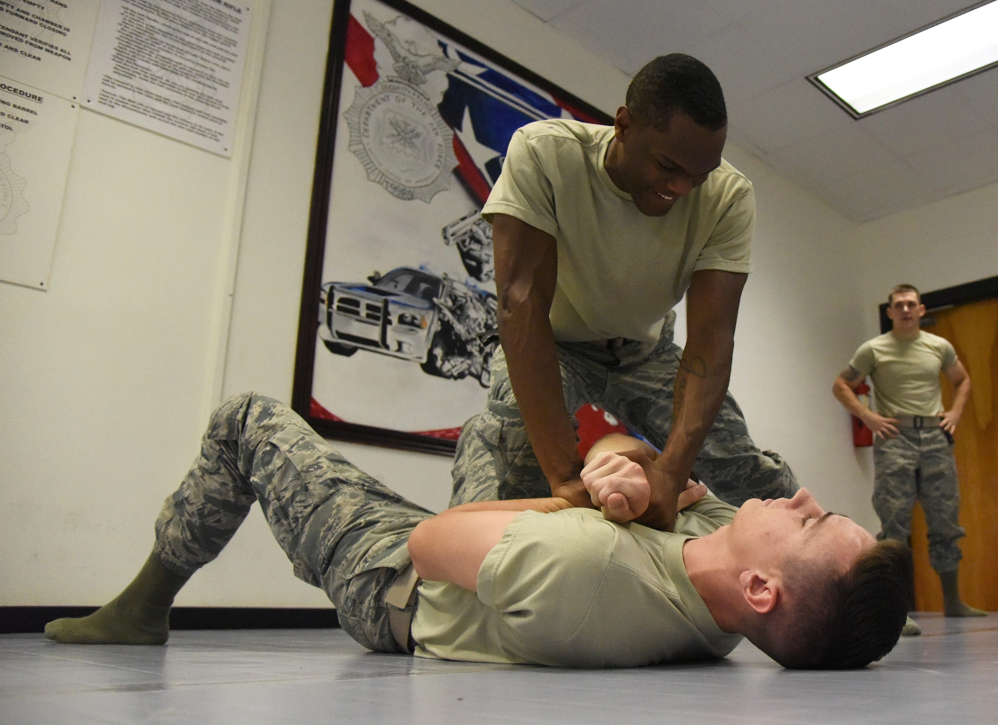 Senior Airman Curtis King II, 81st Security Forces Squadron entry controller, and Airman 1st Class Charles Wynne, 81st SFS entry controller, practice a combative technique during an 81st SFS combative training course at the SFS building Oct. 19, 2017, on Keesler Air Force Base, Mississippi. Approximately 15-20 defenders were taught skills vital to surviving a hand-to-hand ground fight using mixed martial arts and Jiu Jitsu techniques as another tool to survive a confrontational environment. (U.S. Air Force photo by Kemberly Groue)