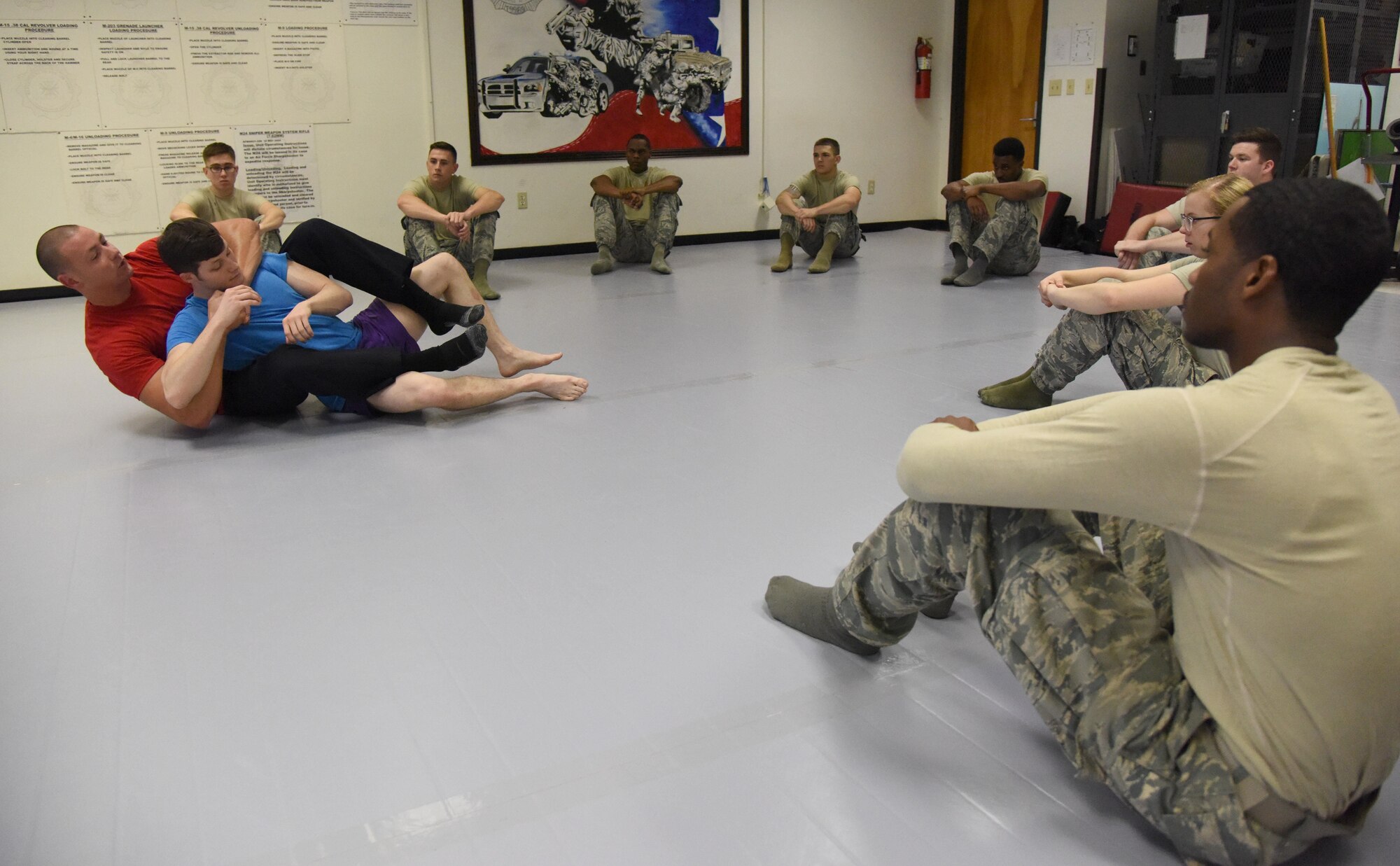 Officer Justin Depew, 81st Security Forces Squadron unit trainer, and Staff Sgt. Clarence Rainey, 81st SFS base defense operations center controller, demonstrate a combative technique during an 81st SFS combative training course at the SFS building Oct. 19, 2017, on Keesler Air Force Base, Mississippi. Approximately 15-20 defenders were taught skills vital to surviving a hand-to-hand ground fight using mixed martial arts and Jiu Jitsu techniques as another tool to survive a confrontational environment. (U.S. Air Force photo by Kemberly Groue)