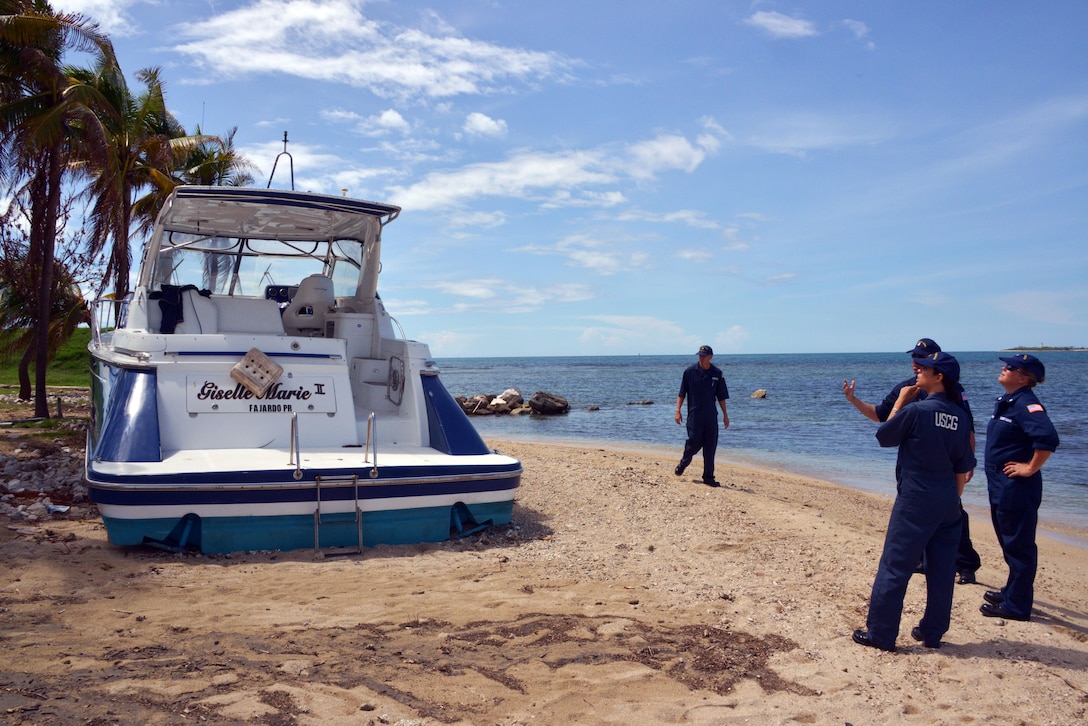 Members survey a grounded boat.