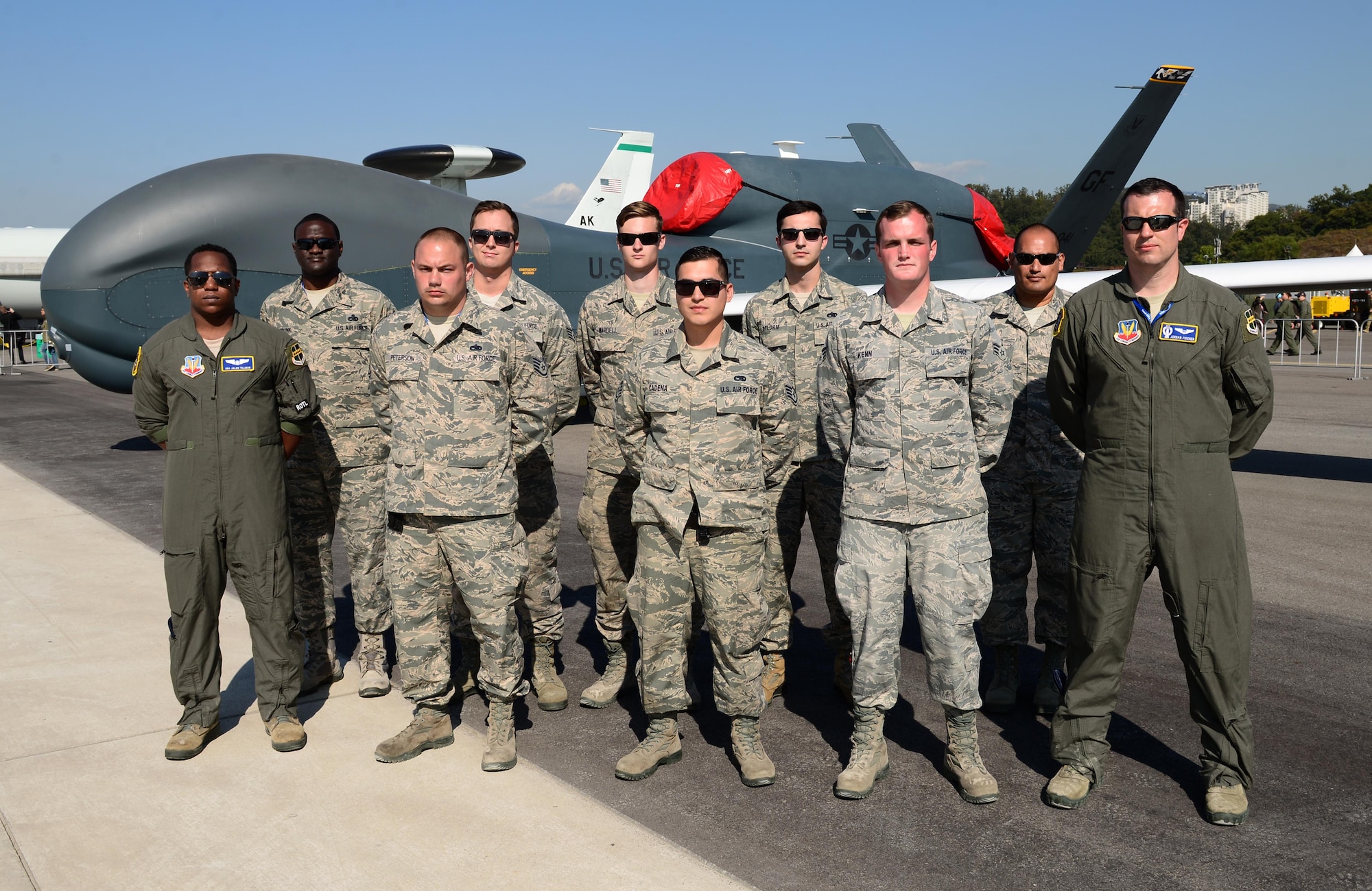 Grand Forks Air Force Base Airmen gather in front of their RQ-4 Global Hawk remotely piloted aircraft during the Seoul International Aerospace and Defense Exhibition 2017 at the Seoul Airport, Republic of Korea, October 20, 2017. The Seoul ADEX is the largest, most comprehensive event of its kind in Northeast Asia, attracting aviation and aerospace professionals, key defense personnel, aviation enthusiasts and the general public alike. (U.S. Air Force photo by Staff Sgt. Alex Fox Echols III)