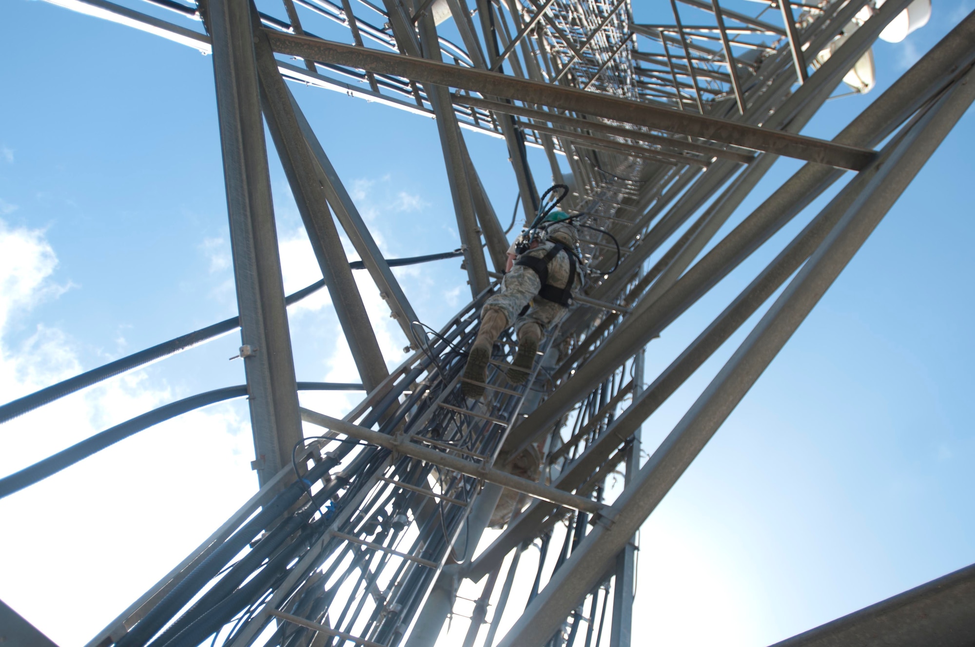 An airman with the 85th Engineering and Installation Squadron, 38th Cyberspace Engineering Installation Group, 688th Cyberspace Wing from Keesler Air Force Base, Mississippi climbs a radio tower October 20, 2017 at Cerro de Punta mountain near Ponce, Puerto Rico. The 85th EIS are working to reestablish and improve radio communications for local emergency personnel and first responders across the island.