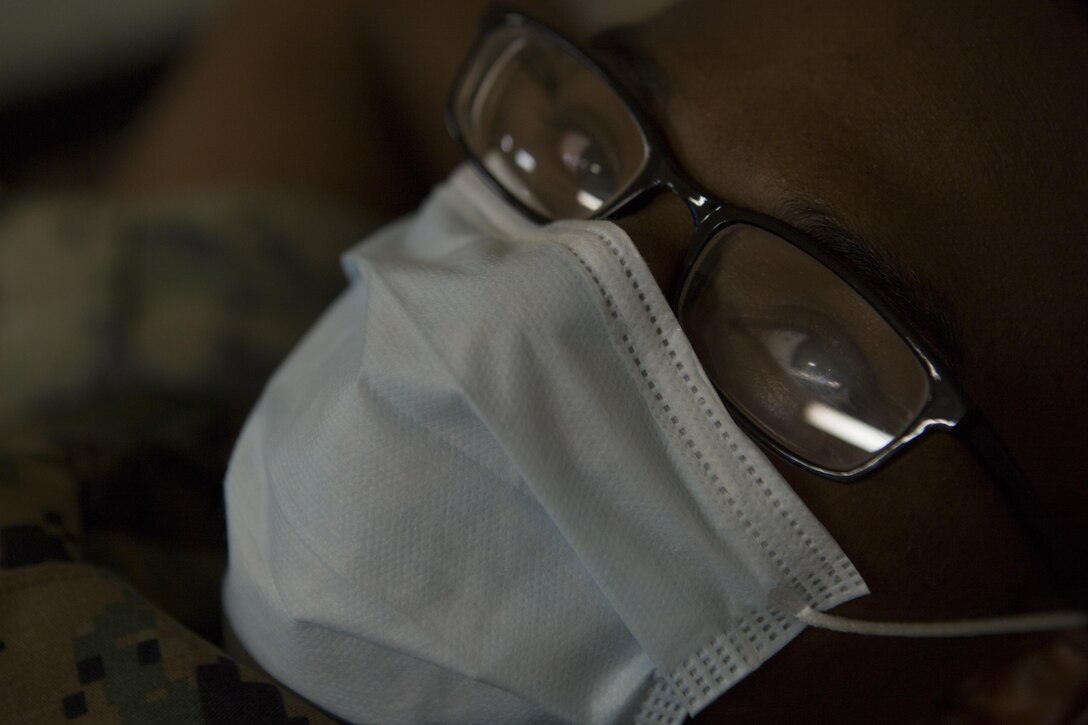 CAMP FOSTER, OKINAWA, Japan— Lance Cpl. Timothy Slack role-plays as a patient Oct. 18 during the pandemic influenza isolation exercise aboard Camp Foster, Okinawa, Japan.