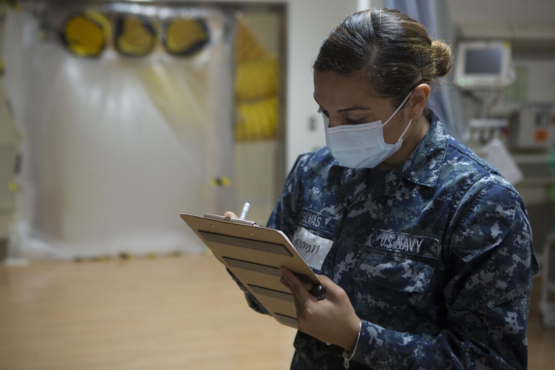 CAMP FOSTER, OKINAWA, Japan— Seaman Kimberly D. Silvas takes notes Oct. 18 during the pandemic influenza isolation exercise aboard Camp Foster, Okinawa, Japan.