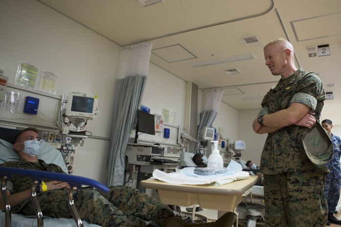 CAMP FOSTER, OKINAWA, Japan—Brig. Gen. Paul J. Rock Jr. speaks to an exercise role-player Oct. 18 during the pandemic influenza isolation exercise aboard Camp Foster, Okinawa, Japan.