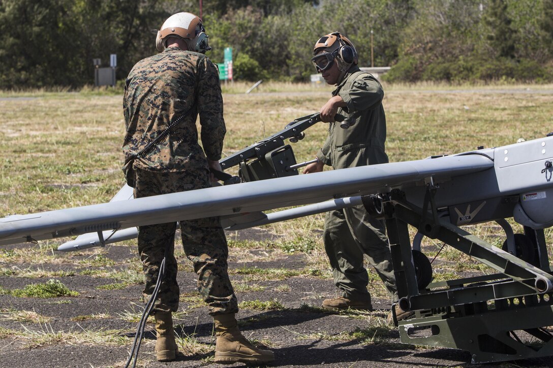 U.S. Marines with Marine Unmanned Aerial Vehicle Squadron 3, start the engine of an RQ-7B Shadow unmanned aerial system during a training event at Landing Zone Westfield, Marine Corps Air Station Kaneohe Bay, Oct. 18, 2017. The purpose of the event is to conduct UAS operations with a minimal amount of personnel and equipment after flying a system in by KC-130J in order to operate immediately within a short amount of time. (U.S. Marine Corps photo by Lance Cpl. Isabelo Tabanguil)