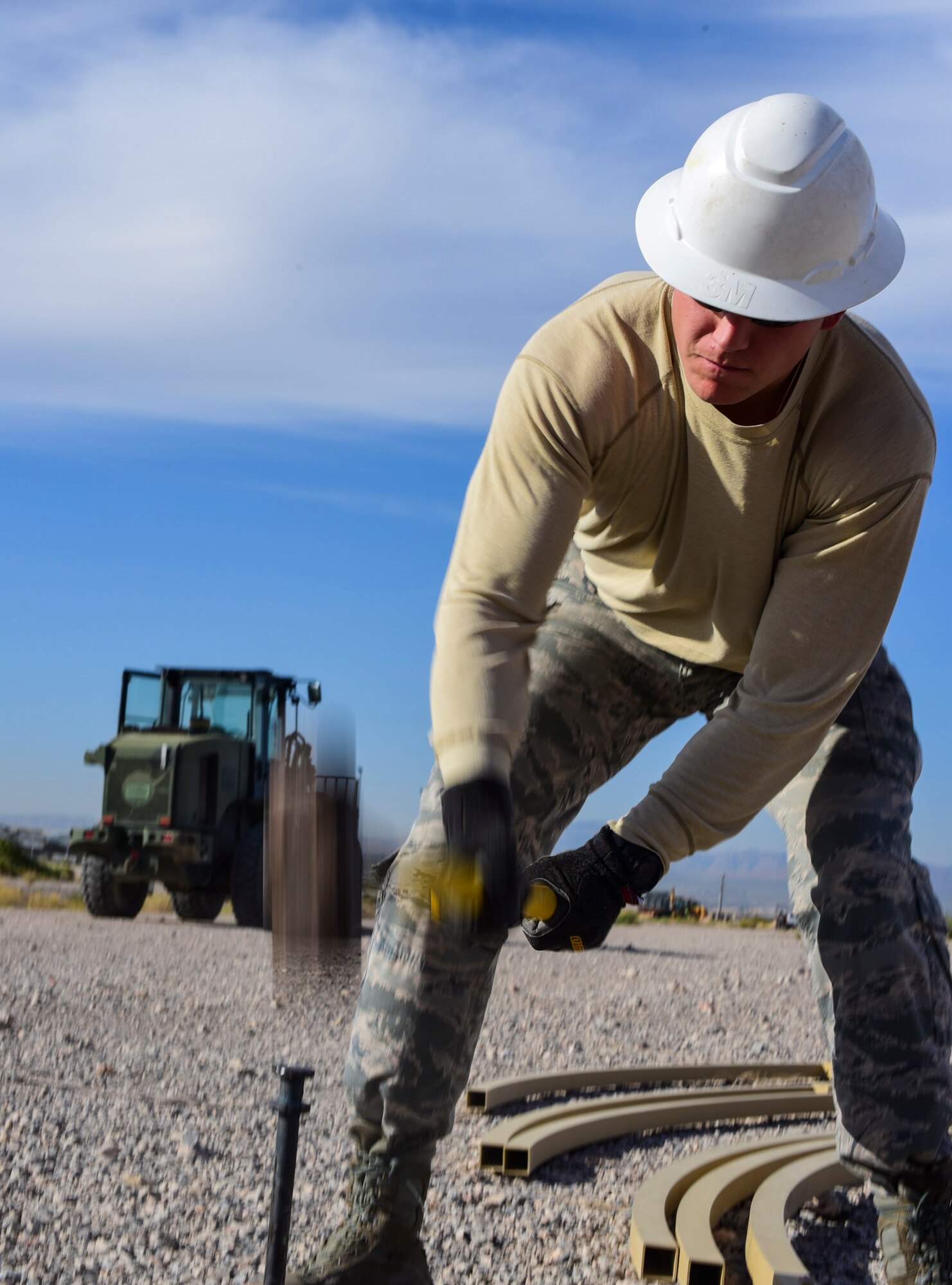 Airman 1st Class Kolbey Adams, 99th Civil Engineer Squadron structural engineer, uses a sledgehammer to drive a stake into the ground during a base emergency engineer force training exercise at Nellis Air Force Base, Nevada, Oct. 19, 2017. More than a dozen Airmen worked together to build shelters during the training exercise. (U.S. Air Force photo by Airman 1st Class Andrew D. Sarver/Released)