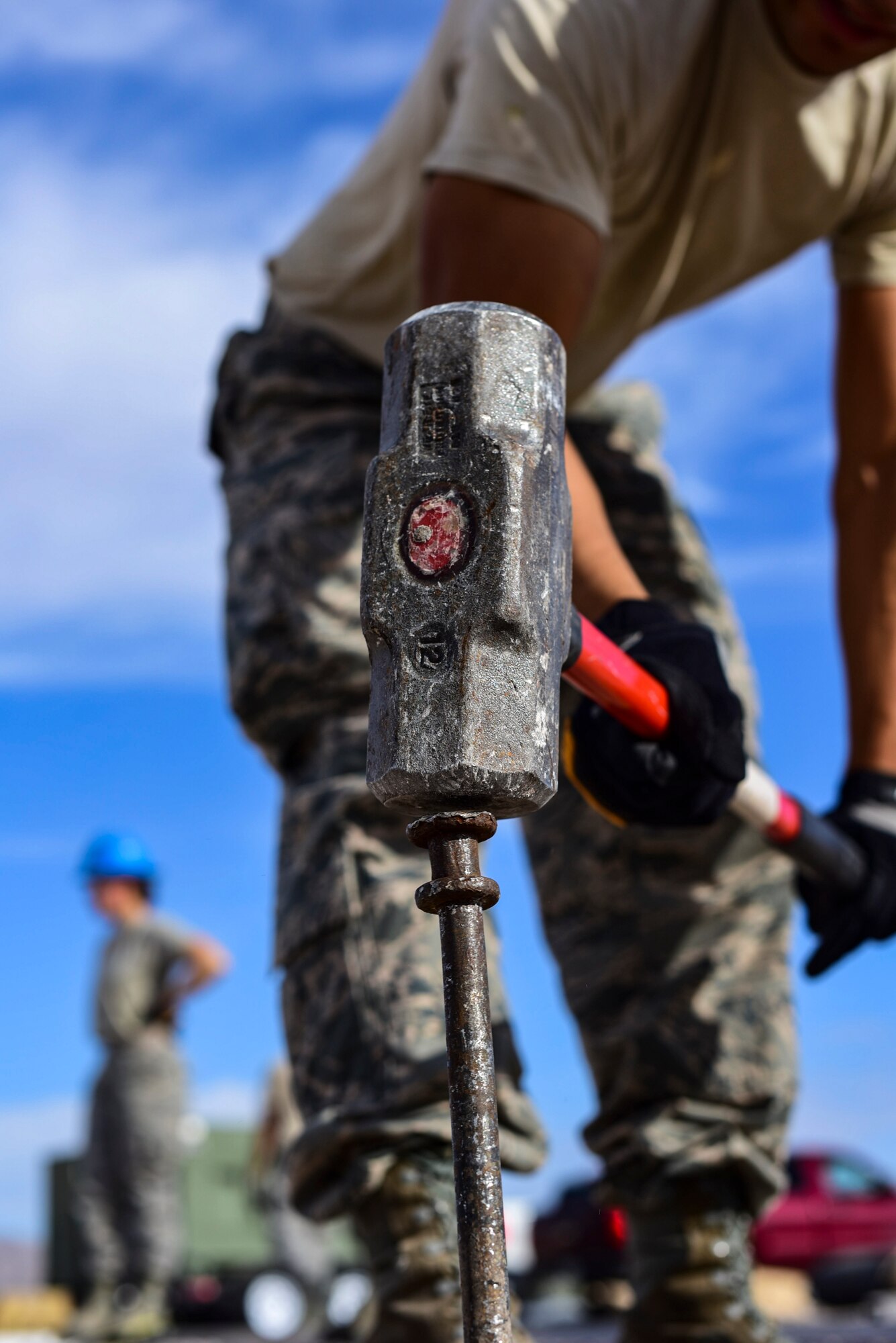 A 99th Civil Engineer Squadron structural engineer drives a stake into the ground during a base emergency engineer force training exercise at Nellis Air Force Base, Nevada, Oct. 19, 2017. The 99th CES conducted their monthly base emergency engineer force training exercise to practice bare base setup and airfield repair. (U.S. Air Force photo by Airman 1st Class Andrew D. Sarver/Released)