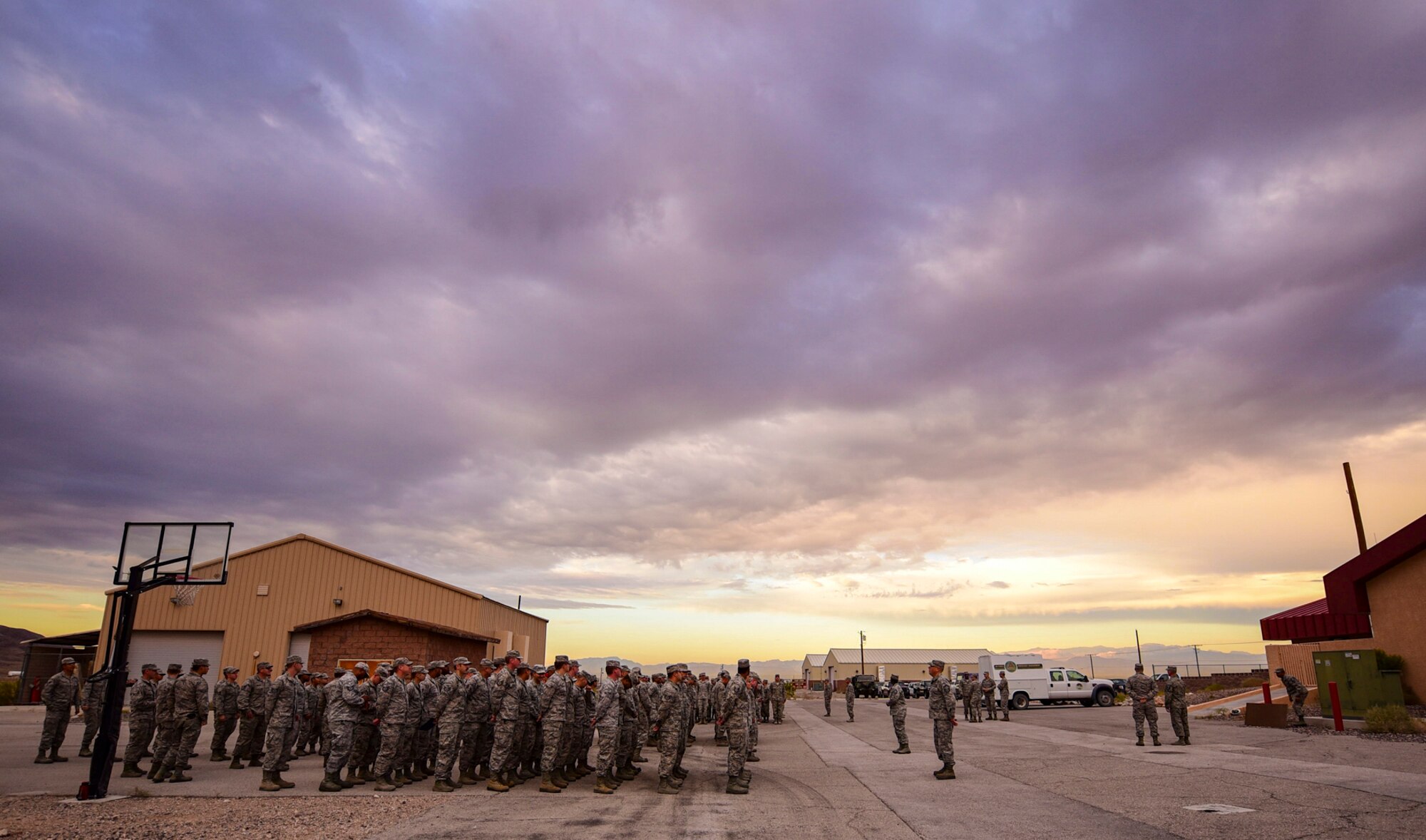 Airmen from the 99th Civil Engineer Squadron fall into formation to kick off their monthly base emergency engineer force training exercise at Nellis Air Force Base, Nevada, Oct. 19, 2017. The training consisted of bare base setup and airfield management. (U.S. Air Force photo by Airman 1st Class Andrew D. Sarver/Released)