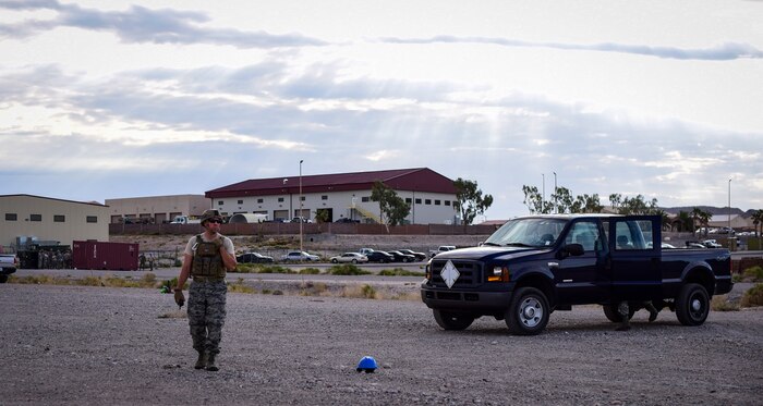 Staff Sgt. Miles Corbin, 99th Civil Engineer Squadron explosive ordnance technician, prepares a cordon around a simulated unexploded ordnance during a monthly base emergency engineer force training exercise at Nellis Air Force Base, Nevada, Oct. 19, 2017. EOD personnel prepare cordons around UXOs to maintain a safe work area. (U.S. Air Force photo by Airman 1st Class Andrew D. Sarver/Released)