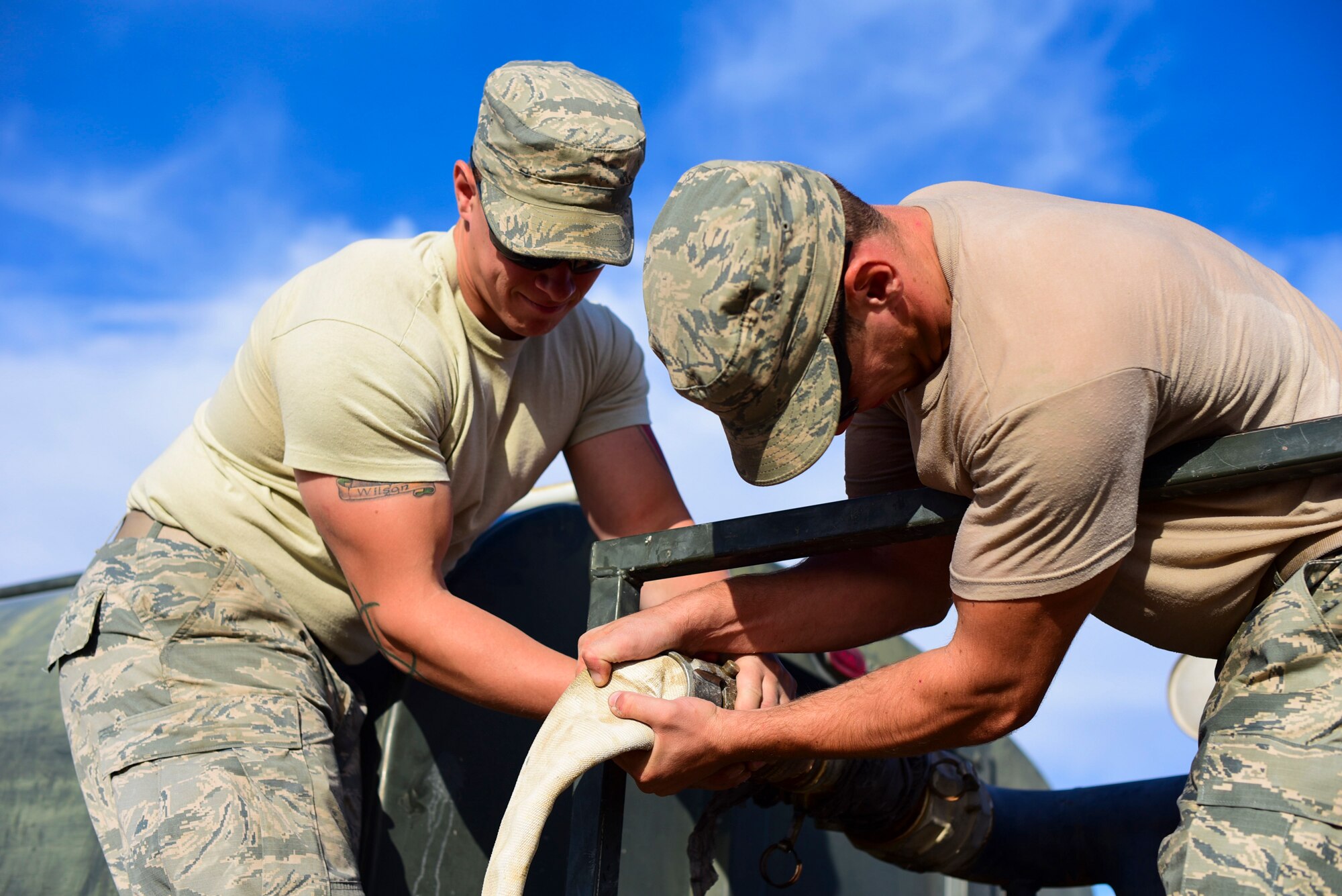 Pavement and construction equipment Airmen from the 99th Civil Engineer Squadron replace a water hose at Nellis Air Force Base, Nevada, Oct. 19, 2017. The 99th CES conducted their monthly base emergency engineer force training exercise to practice bare base setup and airfield repair. (U.S. Air Force photo by Airman 1st Class Andrew D. Sarver/Released)