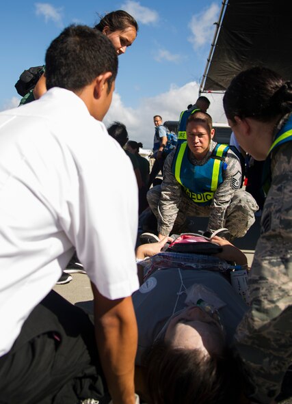 Master Sgt. Donald Prothero, 15th Aerospace Medical Squadron flight chief, moves a patient during the 2017 Triennial Emergency Response Exercise at the Daniel K. Inouye International Airport, Honolulu, Hawaii, Oct. 20, 2017.