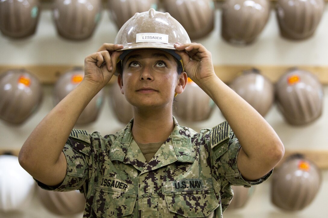 Seaman Apprentice Ariel C. Lissauer dons her hard hat