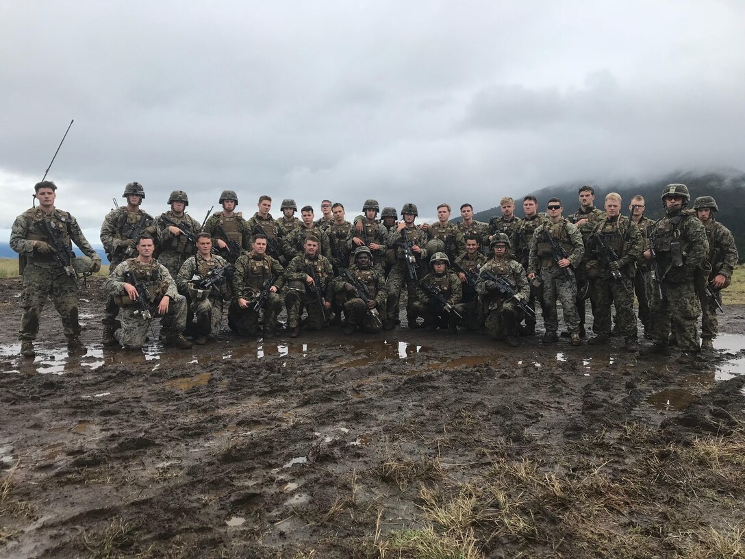U.S. Marines pose for a group photo after finishing the live fire platoon attack range during Exercise Fuji Viper, at Combined Arms Training Center, Camp Fuji, Japan, October 20, 2017. The platoon conducted fire and maneuver drills to simulate closing with an enemy that has occupied their defensive position.  Fuji Viper is a training exercise where Marines conduct live fire and non-live fire combined arms training in order to sustain combat proficiency and improve the lethality of the Marines in the U.S. Pacific Command area of operations. The Marine are with Charlie Company, 1st Battalion, 8th Marine Regiment. 1/8 is attached to 3rd Marine Division as part of the unit deployment program. (U.S. Marine Corps photo by Lance Cpl. Charles Plouffe)