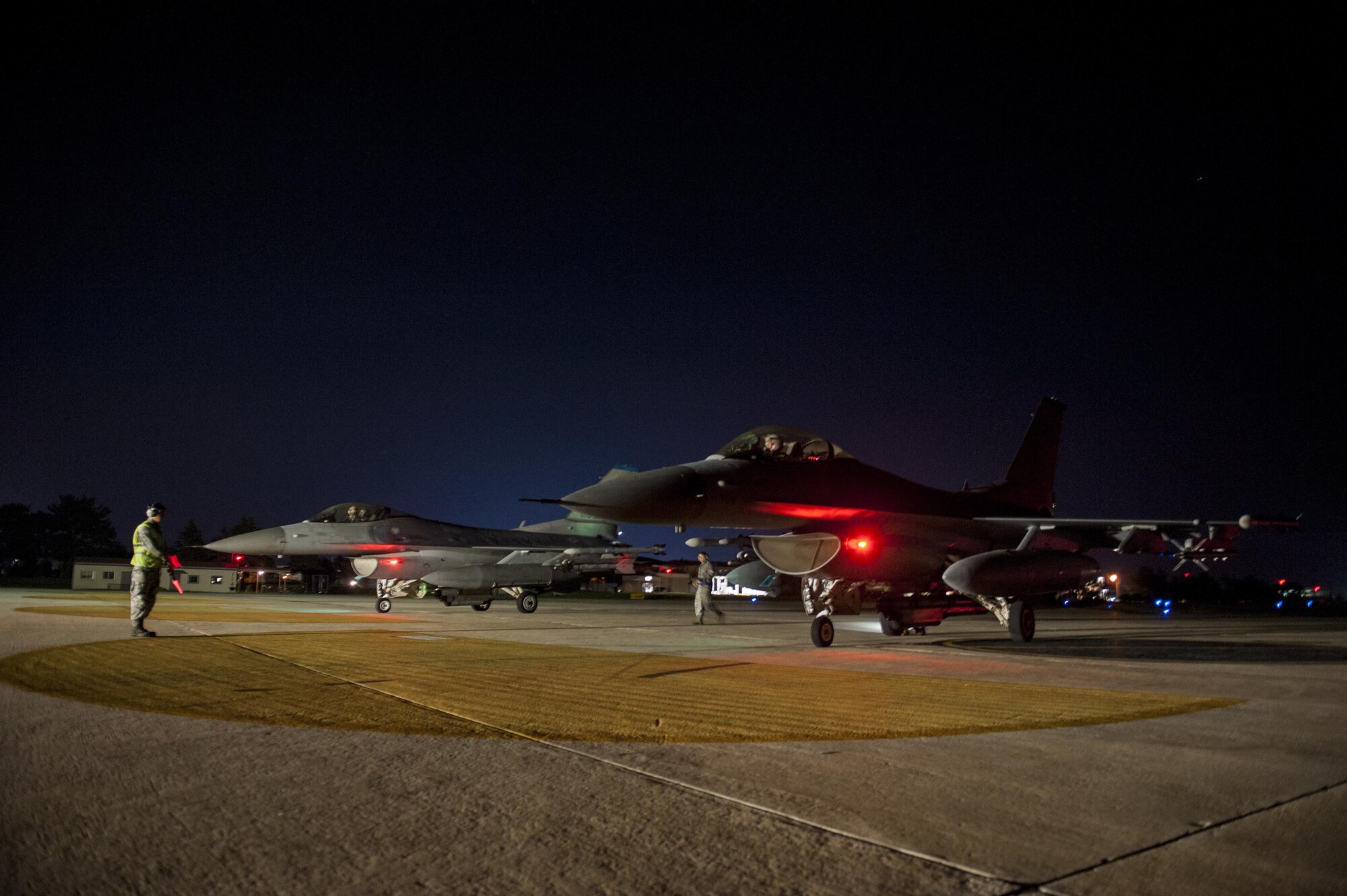U.S. Air Force Airmen First Class Tyler Keiser marshals an F-16 Fighting Falcon at Kunsan Air Base, Republic of Korea, July. 27, 2017.  The F-16 went through final checks before flight. (U.S. Air Force photo by Senior Airman. Coleville Mcfee)