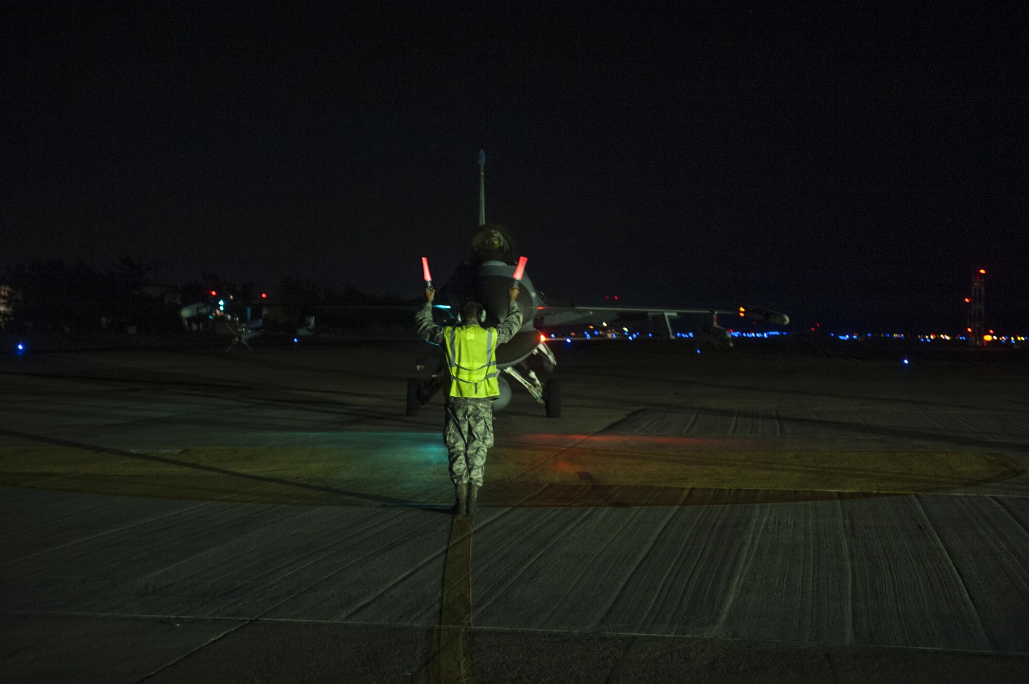 U.S. Air Force Airmen First Class Tyler Keiser marshals an F-16 Fighting Falcon at Kunsan Air Base, Republic of Korea, July. 27, 2017.  The F-16 went through final checks before flight. (U.S. Air Force photo by Senior Airman. Coleville Mcfee)