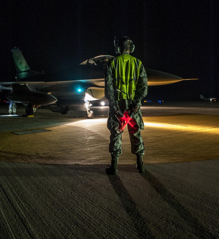 U.S. Air Force Airmen First Class Tyler Keiser marshals an F-16 Fighting Falcon at Kunsan Air Base, Republic of Korea, July. 27, 2017.  The F-16 went through final checks before flight. (U.S. Air Force photo by Senior Airman. Coleville Mcfee)