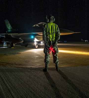 U.S. Air Force Airmen First Class Tyler Keiser marshals an F-16 Fighting Falcon at Kunsan Air Base, Republic of Korea, July. 27, 2017.  The F-16 went through final checks before flight. (U.S. Air Force photo by Senior Airman. Coleville Mcfee)