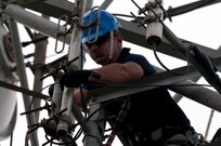 Capt. Jose Gutierrez del Arroyo, deputy flight commander and specialized engineer with the 85th Engineering and Installation Squadron, 38th Cyberspace Engineering Installation Group, 688th Cyberspace Wing from Keesler Air Force Base, Mississippi works on a damaged antenna attached to a radio tower October 20, 2017 at Cerra de Punta mountain near Ponce, Puerto Rico. The 85th EIS are working to reestablish and improve radio communications for local emergency personnel and first responders across the island.