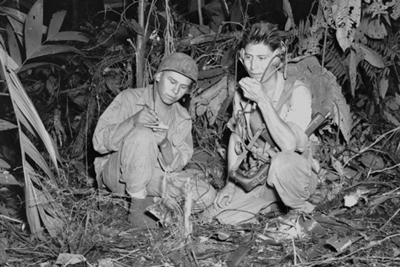 Navajo code talkers use radios to communicate in 1943.