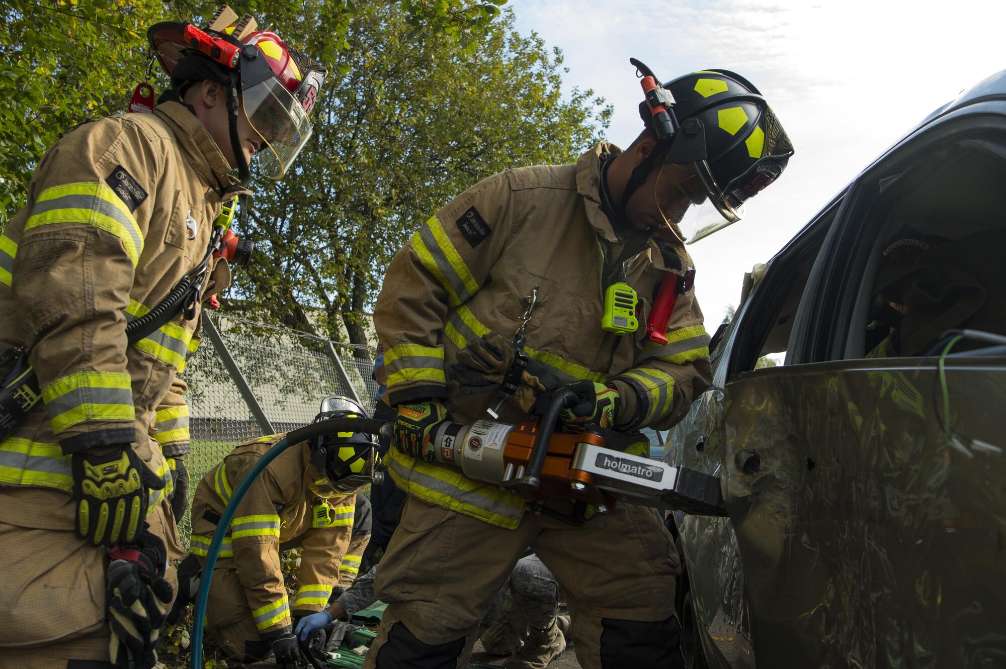 U.S. Air Force Staff Sgt. Anthoney Williams, left, and Senior Airman Kevin Maclean, right, 52nd Civil Engineer Squadron firefighters, use the Jaws-of-Life to extract a victim from a simulated vehicle accident at Spangdahlem Air Base, Germany, Oct. 19, 2017. Airmen from the 52nd CES and 52nd Medical Operations Support Squadron train together to practice and execute skills needed for real world scenarios. (U.S. Air Force photo by Senior Airman Dawn M. Weber)