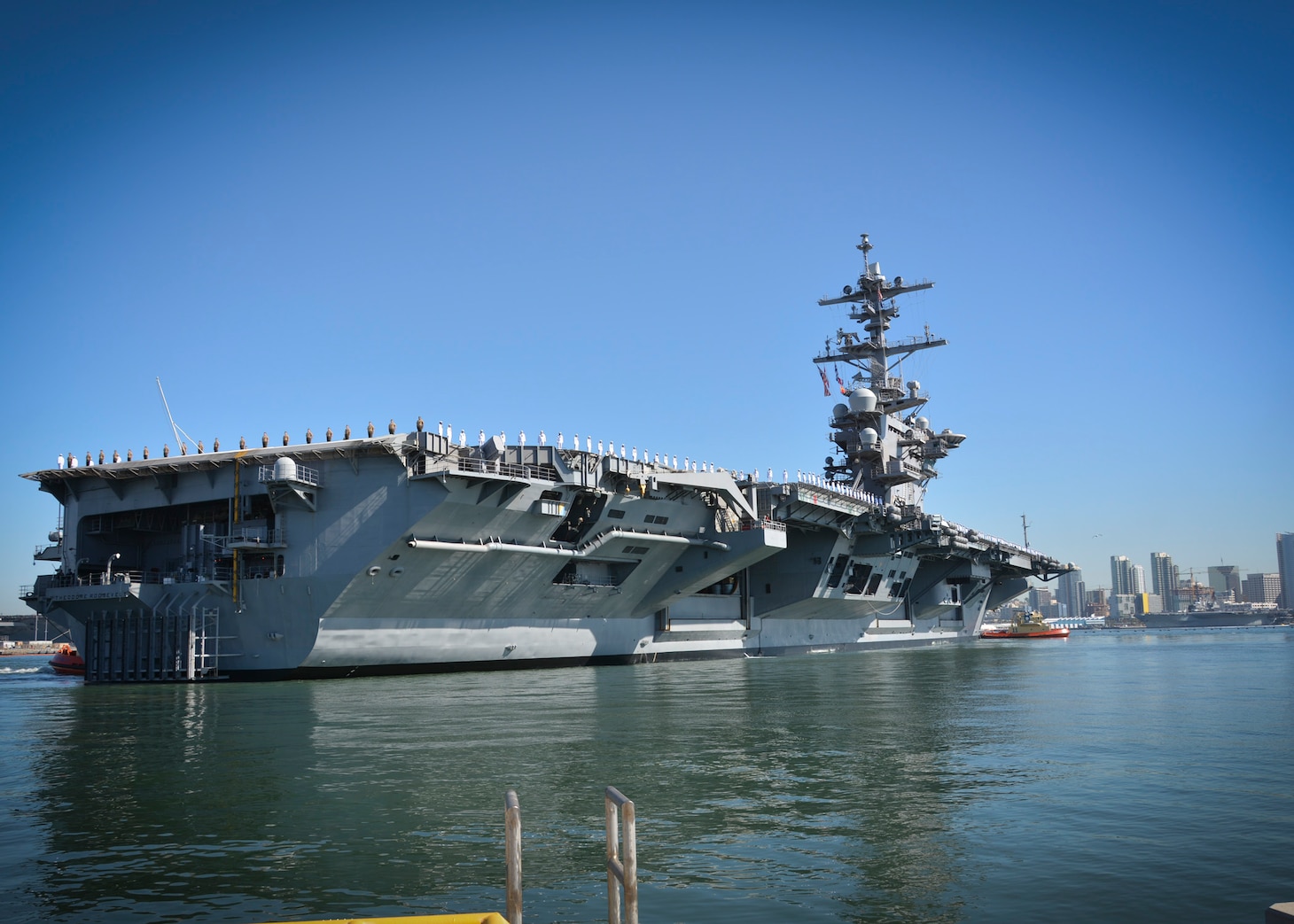 SAN DIEGO (Oct. 6, 2017) Sailors and Marines aboard the aircraft carrier USS Theodore Roosevelt (CVN 71) man the rails as the ship departs its homeport of San Diego. Theodore Roosevelt departed San Diego for a regularly scheduled deployment to the U.S. 7th and 5th Fleet areas of responsibility, in support of maritime security operations and theater security cooperation efforts.