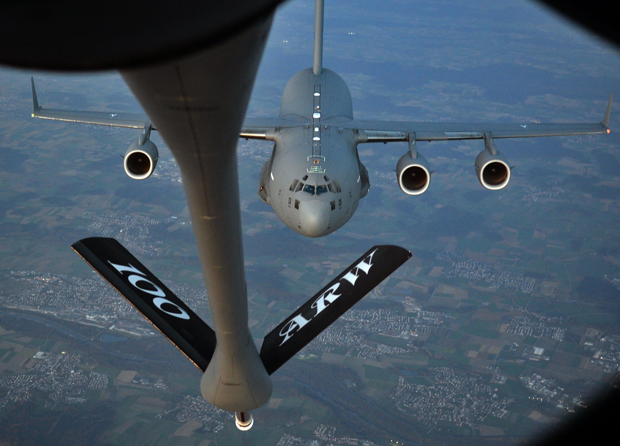 A C-17 Globemaster III flies behind a U.S. Air Force KC-135 during an aerial-refueling training exercise over Germany, Oct. 19, 2017. The C-17 was operated by the Heavy Airlift Wing, Papa Air Base, Hungary, which is comprised of approximately 145 personnel from 12 nations. (U.S. Air Force photo by Airman 1st Class Luke Milano)