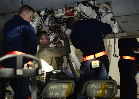 Airmen from the 31st Maintenance Squadron attach a retract actuator to an F-16 Fighting Falcon Oct. 18, 2017, at Aviano Air Base, Italy. A retract actuator pulls the landing gear into the jet. (U.S. Air Force photo by Airman 1st Class Ryan Brooks)
