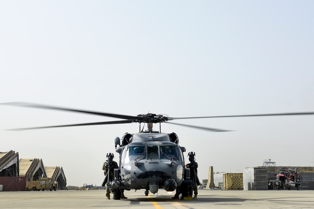 Air Force pilots and crew chiefs prepare their HH-60 Pave Hawk helicopter for takeoff.