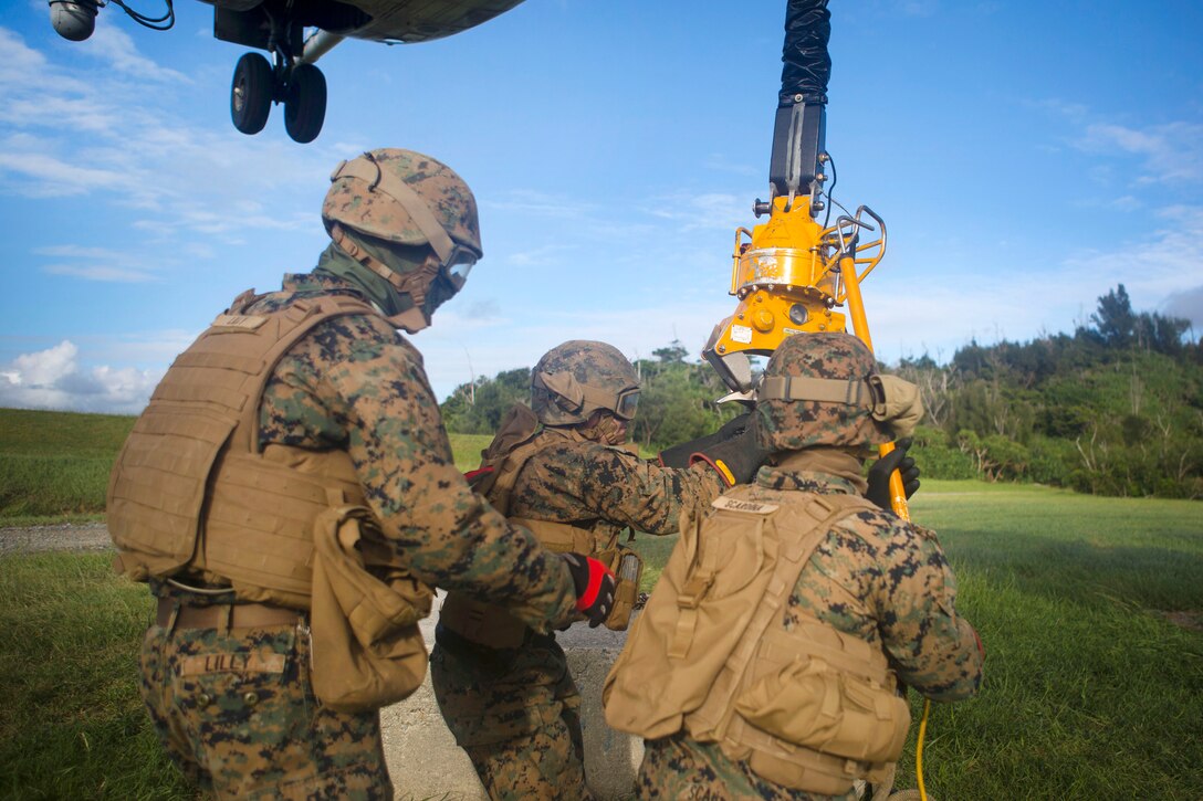 Marines hook up a cement block while conducting external lift drills.