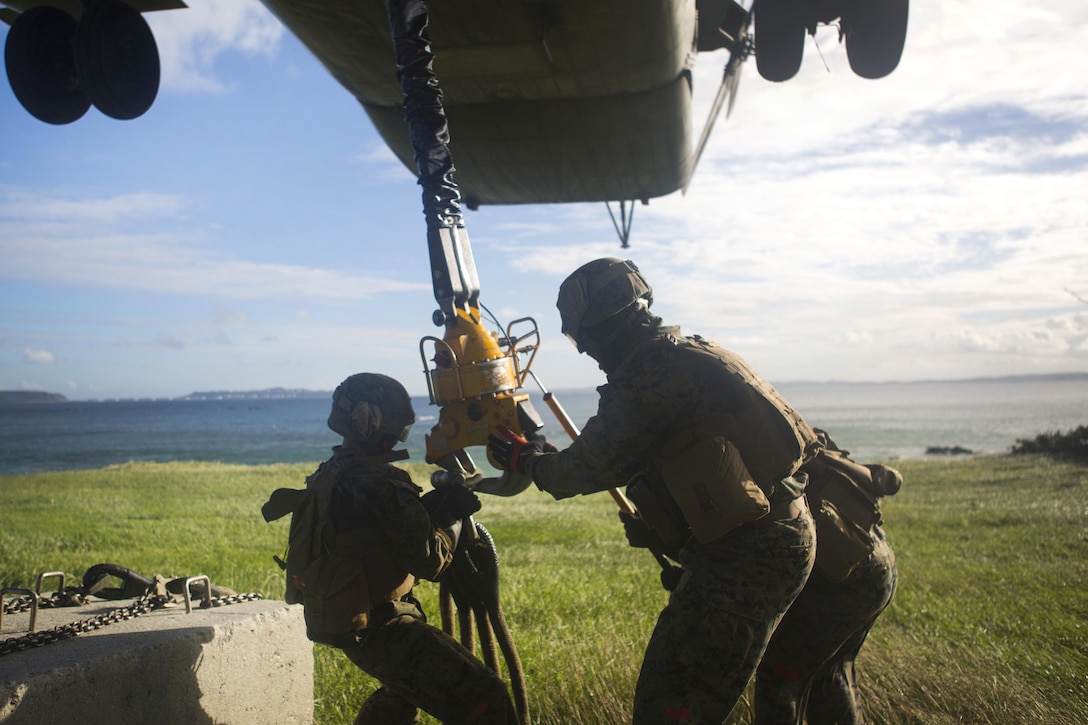 Marines hook up a cement block while conducting external lift drills.