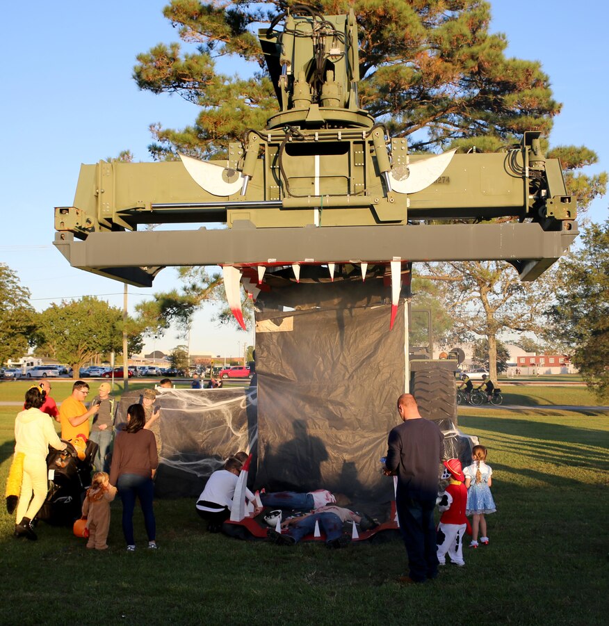 Community members interact with a touch-the-truck display at a Trunk or Treat event at Marine Corps Air Station Cherry Point, N.C., Oct. 19, 2017. Marine Corps Community Services hosted the Halloween-inspired event that included face painting; touch the truck displays; and a family glow dance party. Decorated trunks were judged and the highest-rated contestants received door prizes. (U.S. Marine Corps photo by Pfc. Andrew King/ Released)
