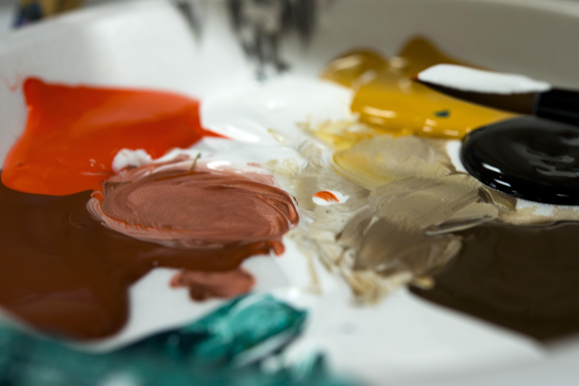 Paint rests on a palette during a Painting with a Twist event, Oct. 21, 2017, at Moody Air Force Base, Ga. The event was geared toward providing fun painting experiences for Active Duty members and their dependents, which can help ease some of the stress they face as military families. During the event, participants went through the steps to paint a festive fall pumpkin.  (U.S. Air Force photo by Airman 1st Class Erick Requadt)