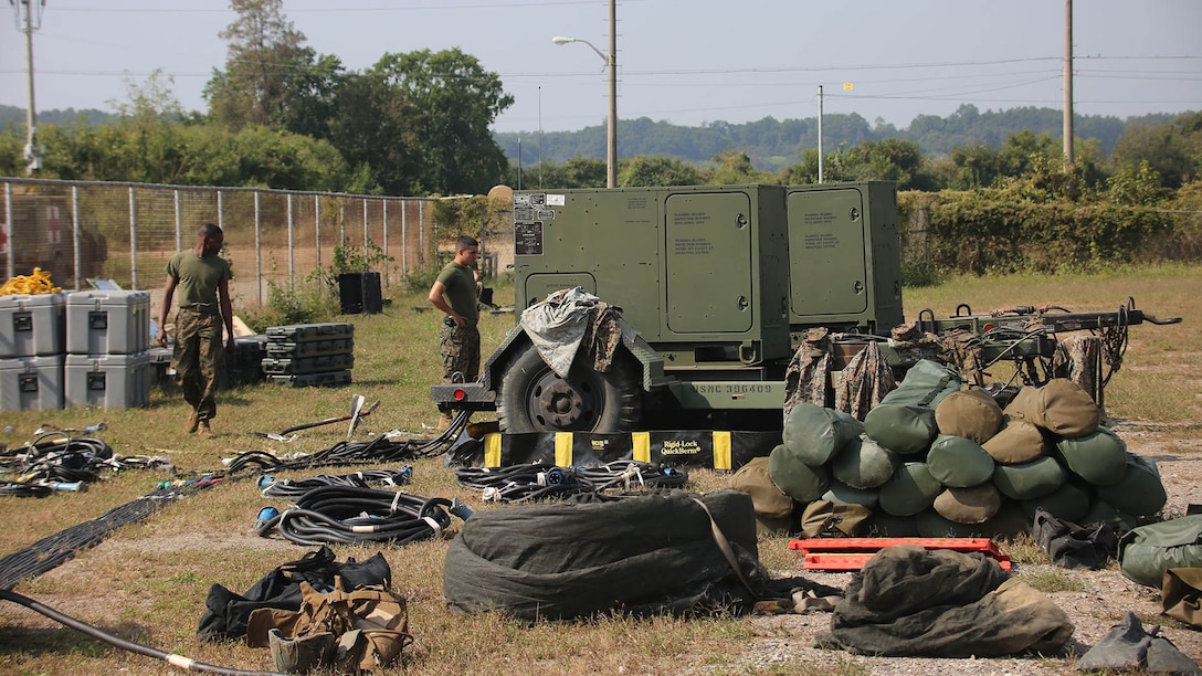 Marines with Marine Air Support Squadron 2, Marine Air Control Group 18, Marine Aircraft Group 36, 1st Marine Aircraft Wing, set up gear