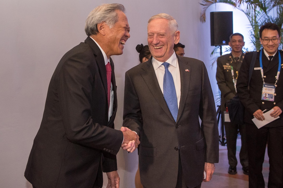 Defense Secretary Jim Mattis shakes hand with the Singaporean defense minister.