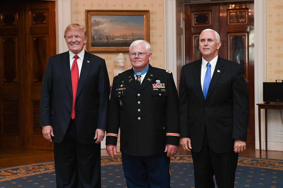 President Donald J. Trump, retired Army Capt. Gary M. Rose and Vice President Mike R. Pence pose for a photo.