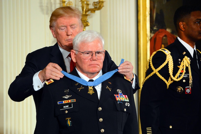 President Donald J. Trump places the Medal of Honor around the neck of retired Army Capt. Gary M. Rose.